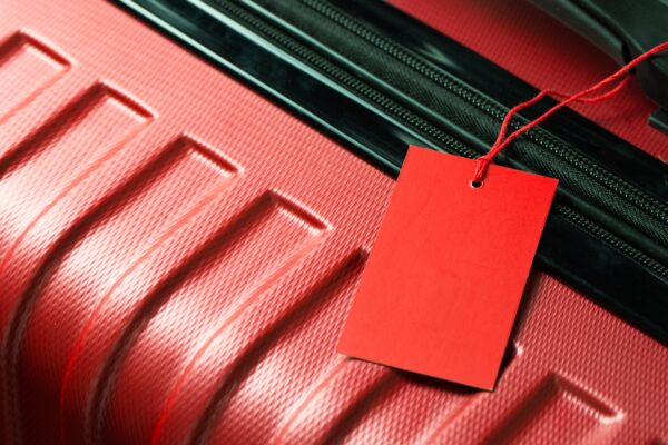 A bright red luggage tag.